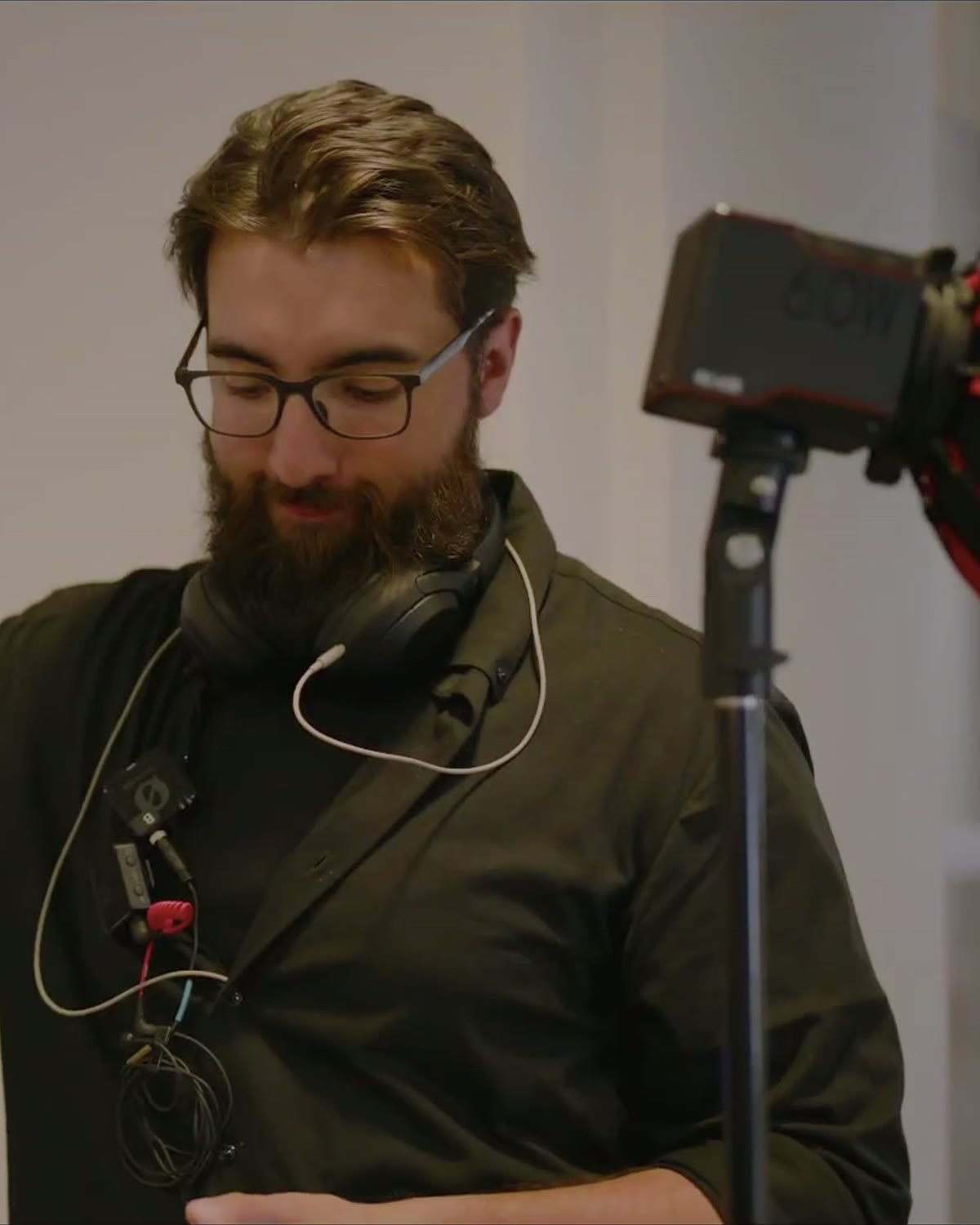 Dennis on set with lighting gear and audio kit